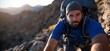 © Bayu - Bearded hiker climbing rocky mountain, close-up.