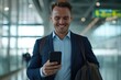 © Harsha - Young businessman using smartphone in airport and office.