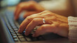 © Yaroslav Stepannikov - Focused woman typing while sitting at a clean and organized office workstation, close up