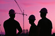 © Luluraschi - engineer team silhouetted against industrial complex, twilight sky, cranes visible