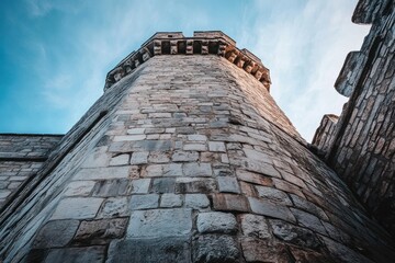 Leinwandbilder - Stone tower with cloudy sky.
