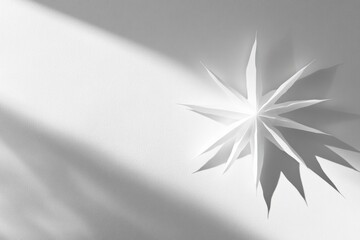 Poster - Paper star with sharp edges and shadows on white surface.