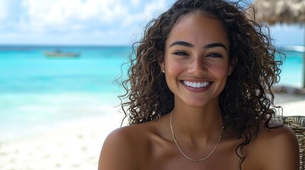 Poster - A woman with beautiful curly hair smiles brightly as she enjoys a sunny day at a tropical beach. The turquoise water sparkles under the sun, creating an idyllic atmosphere