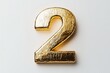 © Denis - Golden number two decoration ideal for celebrations, parties, and milestone events crafted from shiny foil