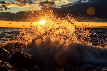 Wall Mural - The sun is setting over the ocean, casting a warm glow on the water. The waves are crashing against the rocks, creating a beautiful and peaceful scene