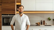 © Ksu_Sha - Smiling man in a modern kitchen with wooden and white cabinetry in warm lighting