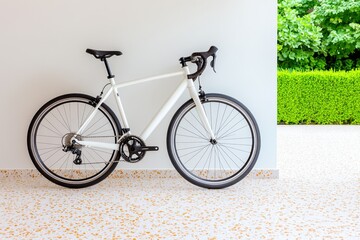 Poster - A clean, minimalist garage design with a single bicycle hanging on a wall and neutral tones throughout