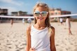 © Igor - summer holidays, vacation, sport and people concept - smiling young woman in sunglasses on the beach