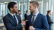 © bteeranan - Two Businessmen Engaging in Conversation in Modern Office Setting