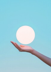 Poster - Minimalist of Hand Holding Glowing Sphere Against Clear Sky