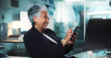 Poster - Mature, business woman or phone in office for stock market research or checking cryptocurrency account. Professional, night trader or happy with smartphone at desk for online news or trading schedule