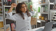 © Krakenimages.com - Young woman stretching in a home decor store surrounded by shelves filled with decorative items
