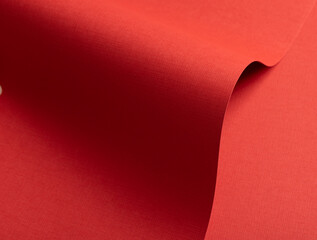 Poster - Rich ruby red paper texture with a crosshatch pattern and fine embossed details. The vibrant surface showcases a warm tone with subtle gradients and wavy shapes, creating a bold