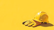 © Thiago - Labor day, yellow construction hard hat resting on a pair of protective work gloves against a matching yellow background. Wrought. Illustration