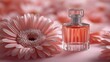 © homeganko - Elegant glass perfume bottle surrounded by delicate pink blossoms on a blue background