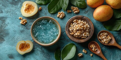 Wall Mural - Top view of fresh apricots with walnuts and a small bowl of blue gel on a textured surface surrounded by green leaves in a natural and rustic setting.