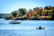 © GrB - Pleasure boat and kayaker approaching an island on a fall day in the St. Lawrence River