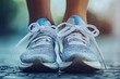 © whitestorm - A close-up of sneakers tied tightly on feet, ready to start a morning run, symbolizing commitment and determination, realistic and sharp