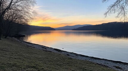 Wall Mural - Serene Sunset Over Calm Lake Surrounded by Nature's Beauty