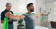 © peopleimages.com - Physiotherapy, stretching or man with resistance band for arms recovery, muscle exercise or health. Mobility help, shoulder or male client with elastic for fitness, physical rehabilitation or balance