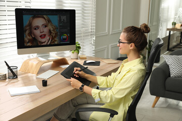 Fototapete - Professional retoucher working on graphic tablet at desk in office