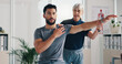 © peopleimages.com - Physical therapy, stretch arm and patient man at consultation for problem, inflammation or shoulder. Person, chiropractor and exercise for injury, rehabilitation and recovery of muscle damage