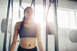 © peopleimages.com - Tired, fitness and woman in gym with weights for intense training, exercise and bodybuilder workout. Sports, athlete and person breathe, sweat and fatigue for wellness, muscle and health in morning