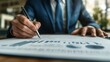 © Munlika - A businessman signing an important investment contract with a pen on a professional document, captured in close-up to highlight the significance of the agreement.
