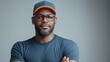© khonkangrua - Confident African American Man with Glasses Wearing Cap and T-Shirt Against Gray Background