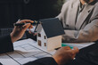 © ARMMY PICCA - Close up Business people or Real Estate agent explain signing agreement for sale house to client. Property, Insurance, Broker concept.