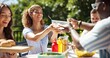 © peopleimages.com - Friends, party and serving lunch outdoor for new year celebration, sharing meal or bonding together. Terrace, people or happy with barbecue food at social event for festive reunion and holiday fun