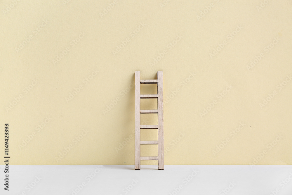 Wooden ladder on beige background