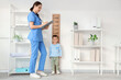 © Pixel-Shot - Female pediatrician with cute little boy measuring height near stadiometer in clinic