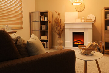 Wall Mural - Interior of cozy living room with fireplace, armchair and coffee table