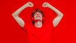 © Atmospheric stock - Young caucasian male enjoying music with headphones against red background