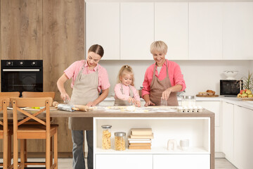 Wall Mural - Happy family with glasses cutting out dough in kitchen