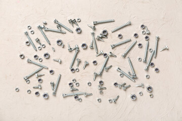 Wall Mural - Different screws and chrome nuts on white grunge background