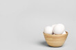 © Pixel-Shot - Bowl with raw chicken eggs on grey background