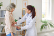 © Studio Romantic - Young female nurse or caregiver measure waist with measuring tape for a senior elderly woman patient standing in medical clinic during examination. Health care in retirement concept.