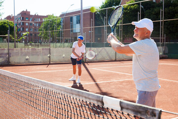 Wall Mural - Grandfather and grandson playing tennis court