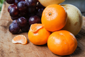 Wall Mural - The concept of Tangerine or Mandarin orange with Grapes and Pears on a white background is suitable for design needs, as an illustration for articles about fruits and others.