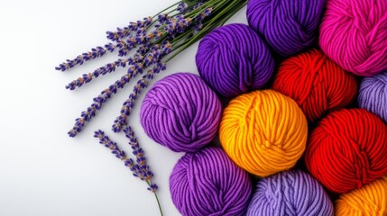 Poster - Bunch of colorful yarns are arranged on a white background with lavender flowers. The colors of the yarns are purple, yellow, and red. The arrangement of the yarns and flowers creates a vibrant