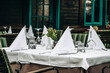 © Andrei Antipov - Elegantly Set Table with a White Tablecloth in a Restaurant