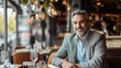 © RENDISYAHRUL - A cheerful businessman is sitting at a restaurant