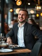 © RENDISYAHRUL - A cheerful businessman is sitting at a restaurant