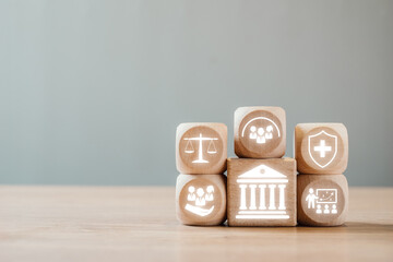 wooden blocks symbolizing social policy elements like justice, healthcare, education, and community 