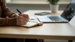 © jamal - Close up, business woman using laptop computer to search the information and taking note on notebook on office table. Student studying online class, e-learning, business planning concept