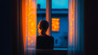 © Jack - Window illuminated by warm light with silhouette of a person during evening hours