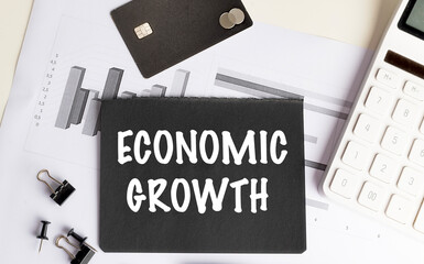 Poster - Black card with the text economic growth, charts, credit card, calculator, and office supplies on a desk