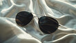 © Visual Aurora - Stylish Aviator Sunglasses on a Smooth Fabric Background